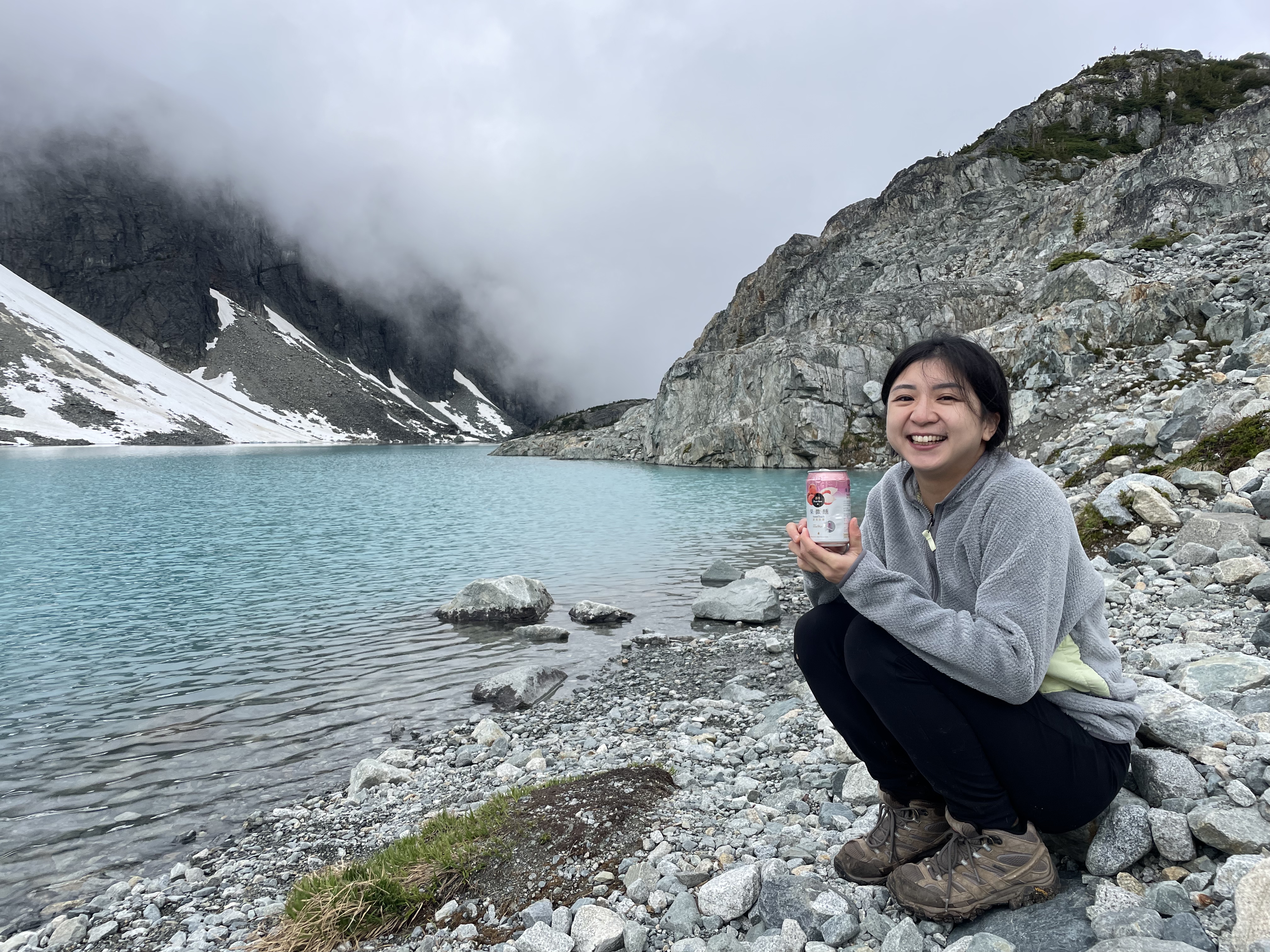 Penny cooling a Taiwanese beer in a glacier lake